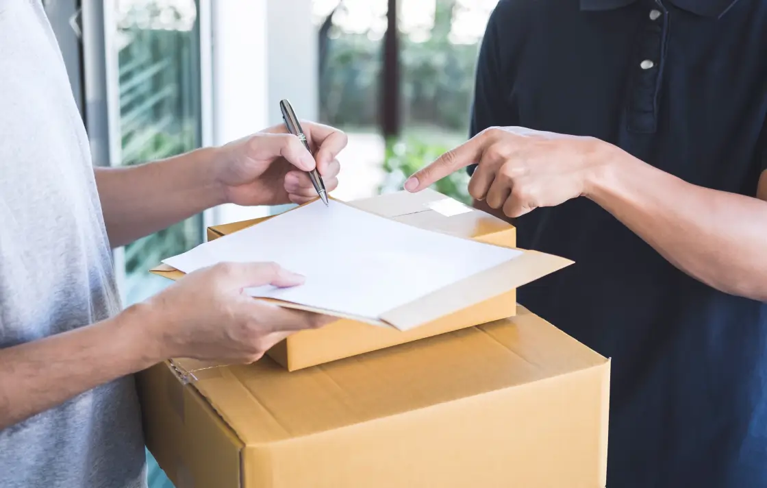 midsection delivery person guiding man signing document 1